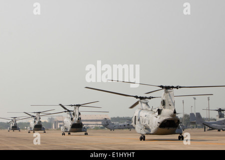Five U.S. Marine Corps CH-46E Sea Knight transport helicopters taxi through U-Tapao International Airport in Nakhon Ratchasima, Stock Photo