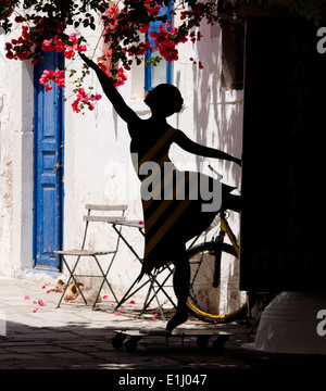 Silhouette of shop sign 'dancer' in Kos Town side street. Stock Photo