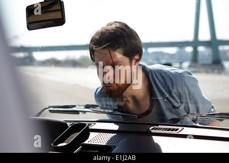 Man kissing front window of a car Stock Photo