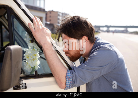 Man kissing front window of a car Stock Photo