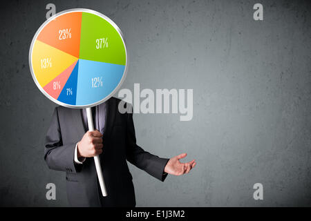 Businessman holding a pie chart Stock Photo