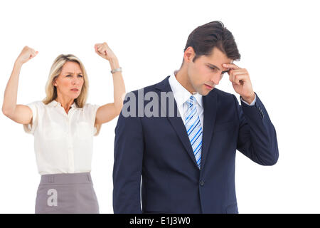 Winning businesswoman her anxious coworker Stock Photo