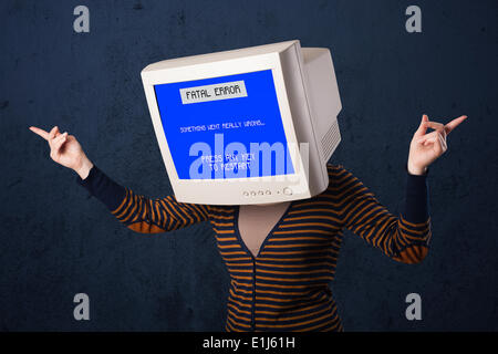 Person with a monitor head and fatal error blue screen on the display Stock Photo