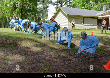 U.S. Airmen, assigned to the 165th Force Support Squadron, Georgia Air National Guard, search for partial remains and personal Stock Photo