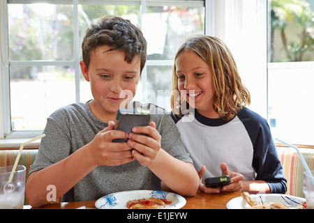 Boys playing handheld video games Stock Photo