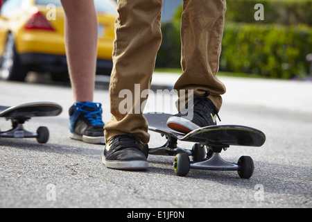 Boys skateboarding, close up Stock Photo