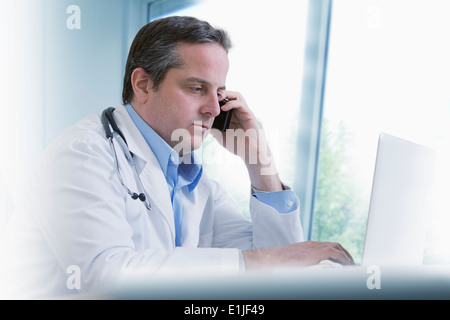 Doctor using mobile phone Stock Photo