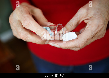 Close up of 82 year old senior woman's hand with pill bottle Stock Photo