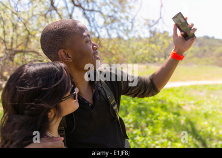 Young couple posing for self portrait in park Stock Photo