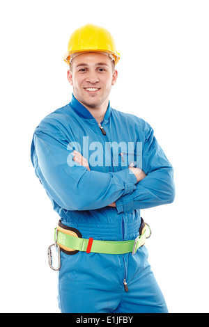 Studio portrait of handsome cheerful worker wearing helmet with arms folded, isolated over white background Stock Photo