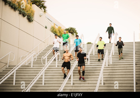 Small group of runners training on convention center stairs Stock Photo