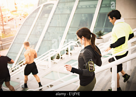 Small group of runners training on convention center steps Stock Photo