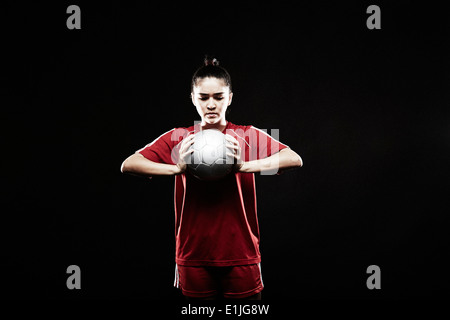 Young woman holding football Stock Photo