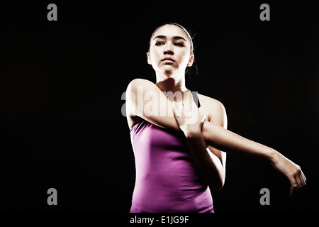 Young woman stretching arm Stock Photo