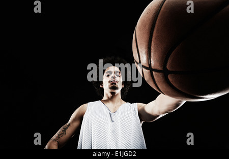 Basketball player holding basketball, low angle Stock Photo