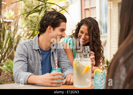 Friends with drinks at backyard barbecue Stock Photo