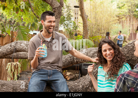 Friends with drinks at backyard barbecue Stock Photo