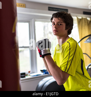 Teenage boy wearing boxing gloves