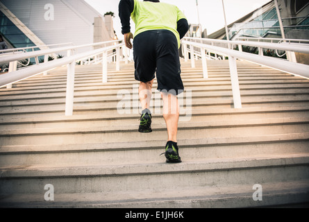 Cropped shot of mature male runner training on steps Stock Photo
