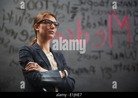 Portrait of businesswoman wearing jacket with writing Stock Photo