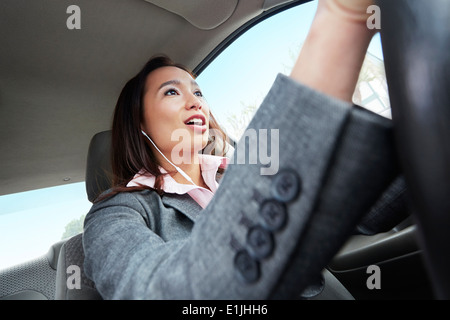Young female businesswoman driving car Stock Photo