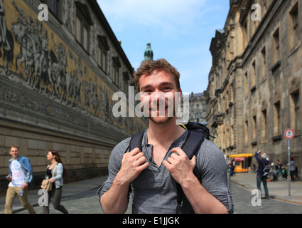 A male student visiting the Fürstenzug (Procession of Princes) in the old town of Dresden. Saxony, Germany. Stock Photo