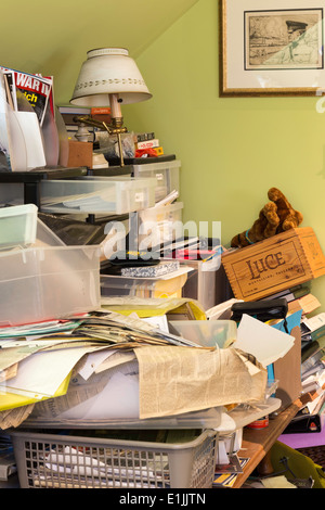 A pile of papers and file folders stacked to overflowing in a black ...