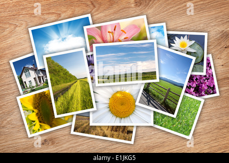 Stack of printed pictures collage on wooden table Stock Photo
