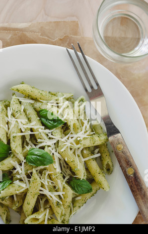 Pasta with Pesto on White Plate with Fork Stock Photo