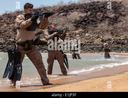 U.S. Marines with the 26th Marine Expeditionary Unit's maritime raid force engage simulated hostile targets during an amphibiou Stock Photo
