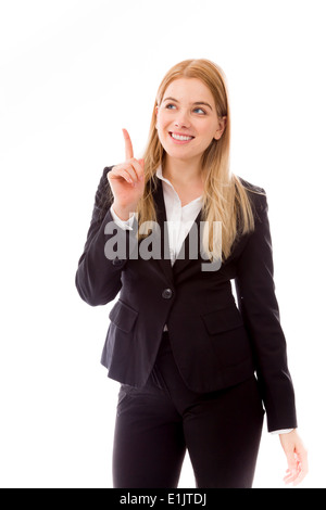 Businesswoman pointing finger upward smiling Stock Photo