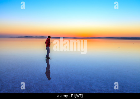 Walking over the water of salt lake Tuz Golu at sunset Stock Photo