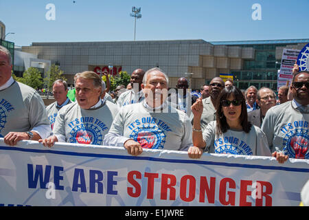 Detroit, Michigan, USA. Dennis Williams (center), the newly-elected president of the United Auto Workers, leads his members on a march through the streets of Detroit at the conclusion of the UAW's constitutional convention. Credit:  Jim West/Alamy Live News Stock Photo