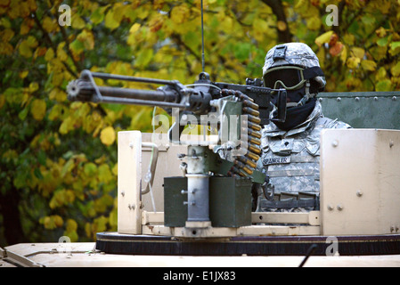 A U.S. Soldier assigned to Alpha Troop, 1st Squadron, 91st Cavalry Regiment, 173rd Infantry Brigade Combat Team scans the terra Stock Photo