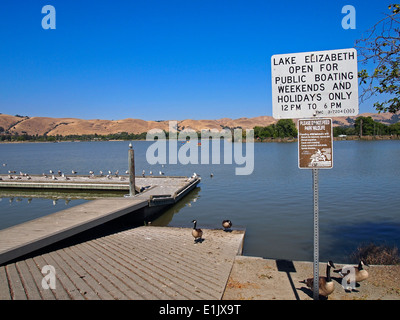 Signs, Do Not feed wildlife, public boating, Lake Elizabeth Fremont California USA Stock Photo