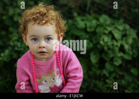 Portrait of a young two year old girl looking bemused Stock Photo