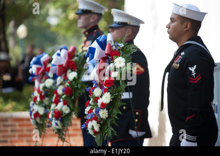 U.S. Marines and Sailors stand during an observance ceremony at the Beirut Memorial in Jacksonville, N.C., Oct. 23, 2013. The Stock Photo