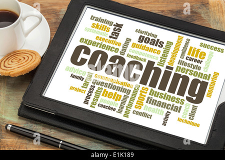coaching concept - a related word cloud on a digital tablet with cup of coffee Stock Photo