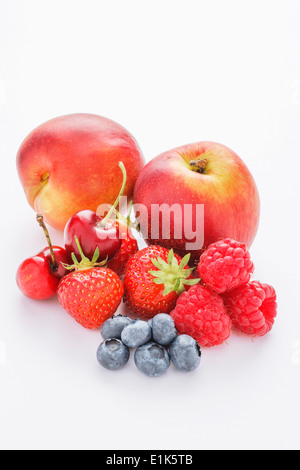 A selection of mixed fruit on a white background These include cherries nectarines strawberries plums blueberries and Stock Photo