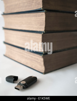 Stack of books with USB memory stick. Blue background Stock Photo - Alamy
