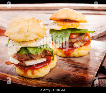 Home made gluten free mini burgers or sliders with beef, egg, lettuce, cheese and sauce Stock Photo