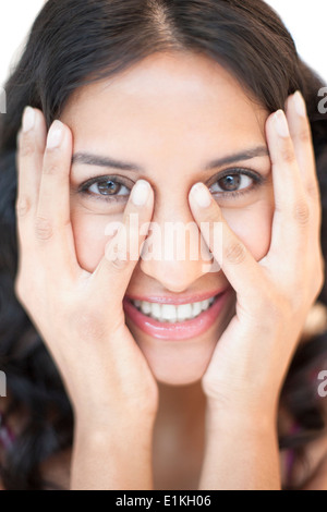 MODEL RELEASED Portrait of a woman with her hands touching her face. Stock Photo