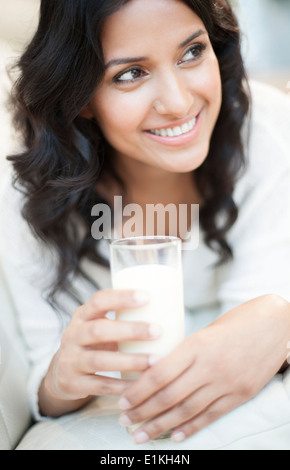 MODEL RELEASED Portrait of a woman holding a glass of milk. Stock Photo