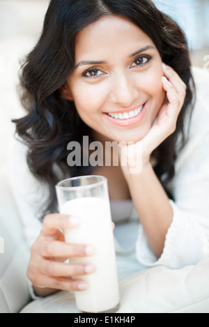 MODEL RELEASED Portrait of a woman holding a glass of milk. Stock Photo