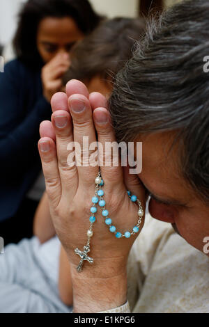 Family praying at home. Stock Photo