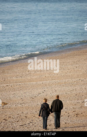 Couple walking on a beach. Stock Photo