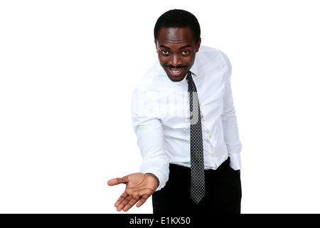 Businessman with open palm offering something over white background Stock Photo