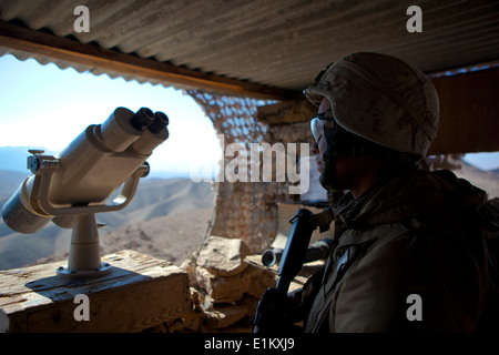 U.S. Marine Corps Cpl. Jonathan Hill, a rifleman with the 3rd Battalion, 7th Marine Regiment, mans a guard post at Observation Stock Photo