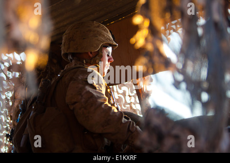 A U.S. Marine with the 3rd Battalion, 7th Marine Regiment stands guard at Observation Post Athens in Helmand province, Afghanis Stock Photo
