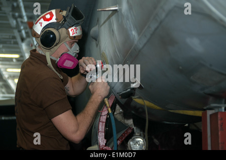 U.S. Marine Corps Lance Cpl. Robert McKelvey, assigned to Marine Fighter Attack Squadron (VMFA) 312, performs corrosion prevent Stock Photo